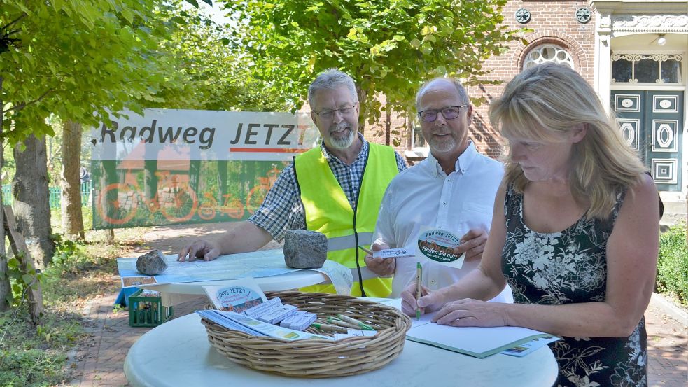 Die Krummhörner Bürgermeisterin Hilke Looden (rechts) unterzeichnet das Unterstützerschreiben für den Radweg an der L4. Die Vorsitzenden des Vereins „Radweglückenschluss an der L4“, Garrelt Agena (Mitte) und Wolfgang Hinrichs, freuen sich sichtlich über die Unterstützung. Foto: Hoppe