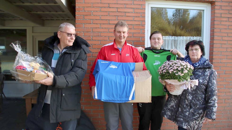 Lothar Maszun (links) und Ehefrau Irina Richter-Maszun spendierten die Trikots und erhielten als Dankeschön von den beiden Trainern Johannes Fleetjer (Zweiter von links, Fortuna Wirdum) und Trainer Hanno Kaliszewski (TV Greetsiel) Dankeschön-Geschenke. Foto: Privat